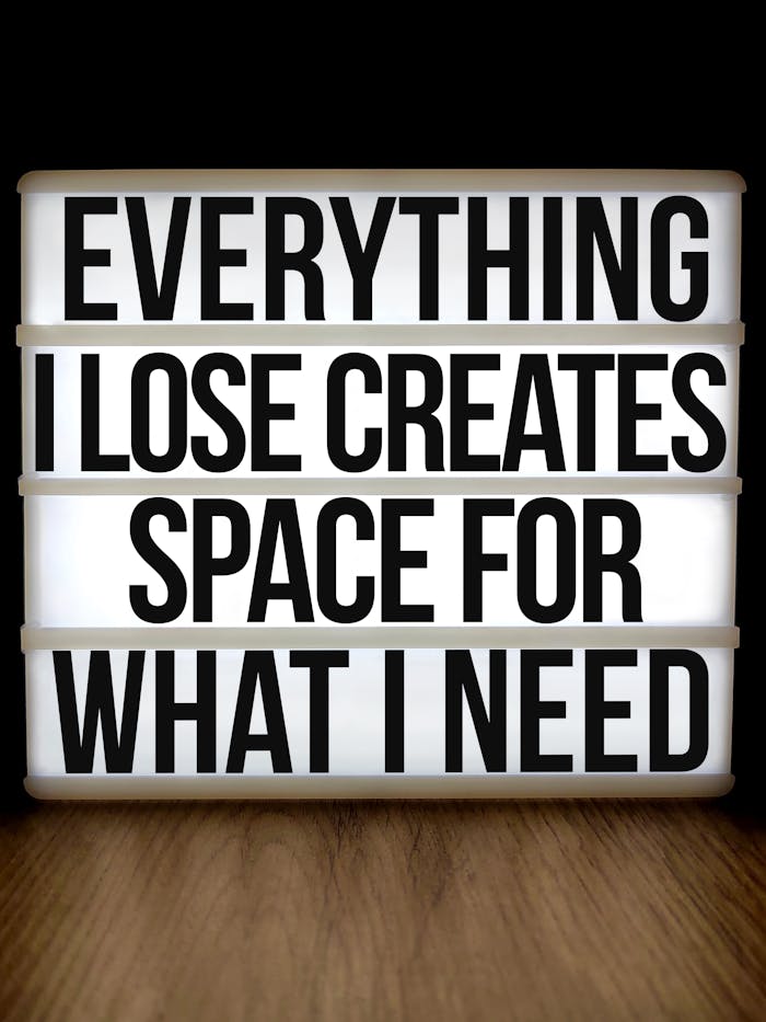 Motivational lightbox with quote: 'Everything I Lose Creates Space for What I Need'.